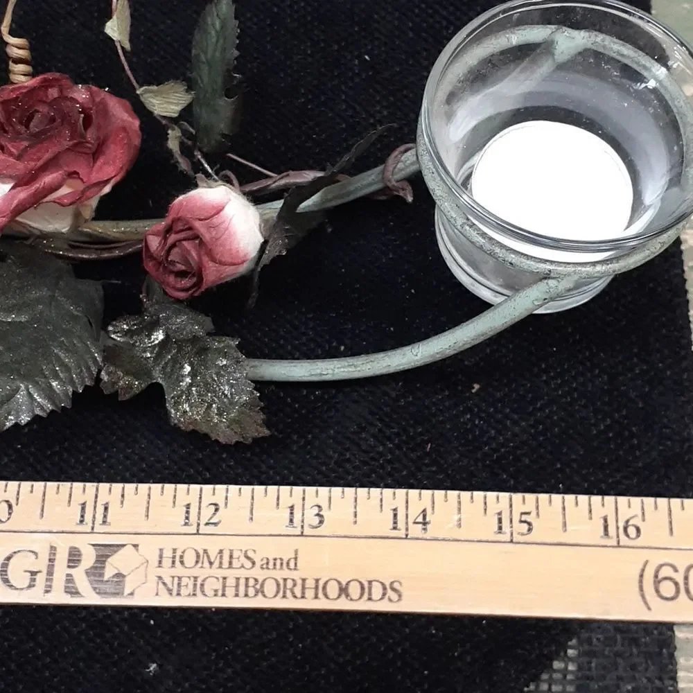Long 3 candle black iron candle holder laced with trailing red roses.‎